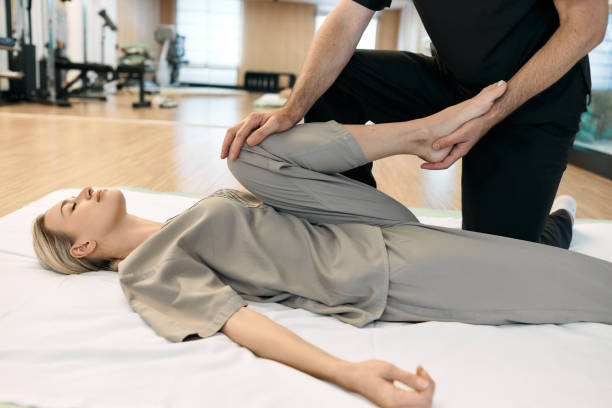 Massage therapist doing some therapeutic massage to the patient